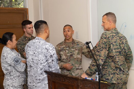  U.S. Marine Corps Col. Thomas Siverts, right, commanding officer of Marine Rotational Force-Southeast Asia, I Marine Expeditionary Force and U.S. Space Force Guardian Capt. Rafael Fermin, a linguist with MRF-SEA speaks with two Philippine Airforce service members at a maritime domain awareness seminar during Exercise Sama Sama 2023, on Fort Bonafacio, Manila, Luzon, Philippines, Oct. 3, 2023. Sama Sama is a multilateral exercise including forces from the Philippines, United States, Australia, France, Japan, Canada and the United Kingdom designed to promote regional security cooperation, enhance maritime interoperability and maintain and strengthen maritime partnerships. MRF-SEA is a Marine Corps Forces Pacific operational model which involves planned exchanges with subject matter experts, promotes security goals with Allies and partners, and positions I MEF forces west of the International Date Line. (U.S. Marine Corps photo by Staff Sgt. Kai W. Huber).