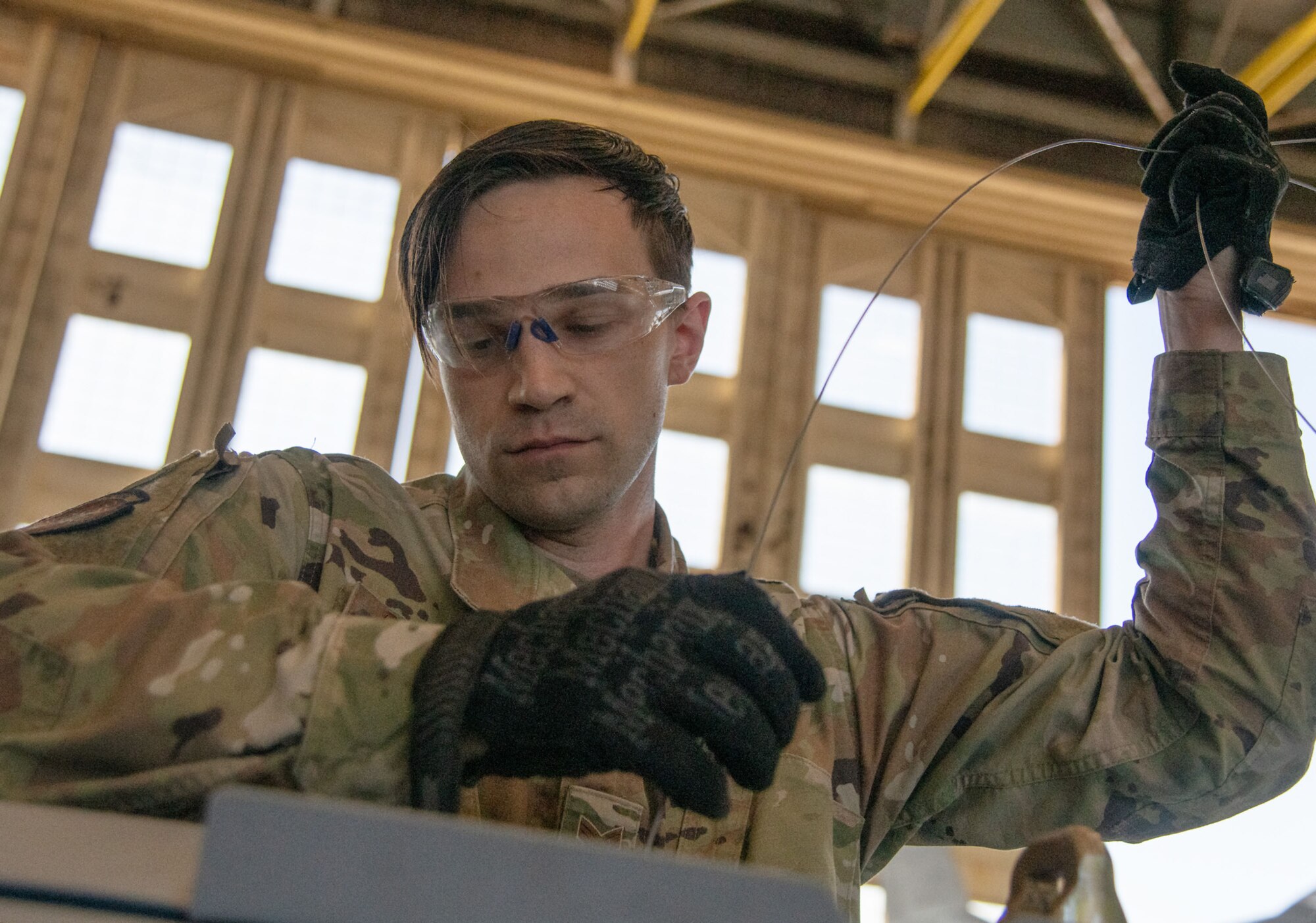 An Airman pulls a fuse through a GBU-31.