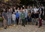 group photo with autumn trees behind them