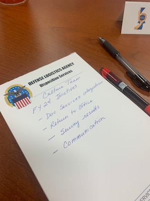 A DLA pad of paper that had hand written notes blurred