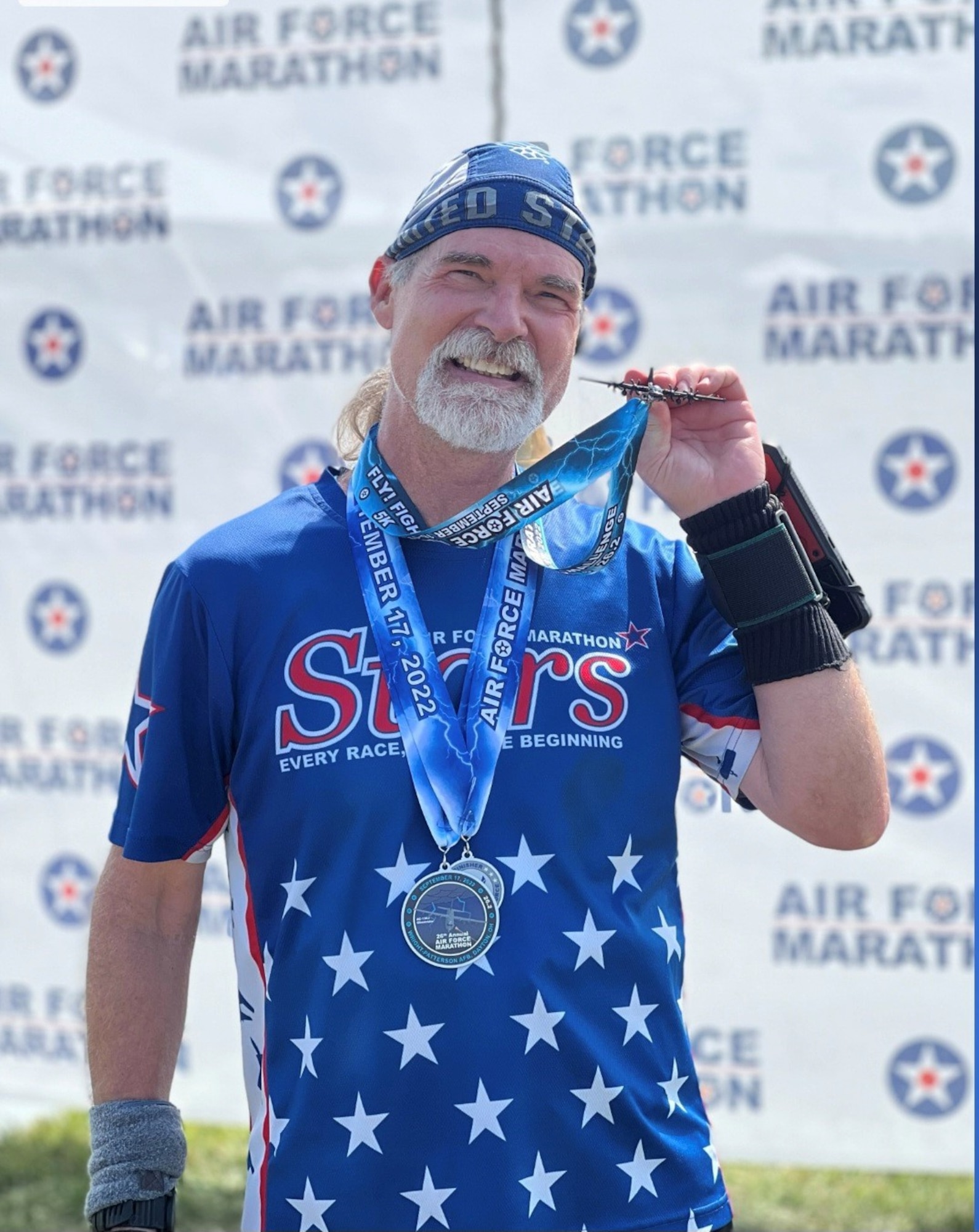 Gary Moroney poses for a photo with his medal upon completion of an Air Force Marathon event at the National Museum of the U.S. Air Force on Wright-Patterson Air Force Base, Ohio, Sept. 17, 2022. Moroney has participated in every Air Force Marathon since its inception. (Courtesy Photo)