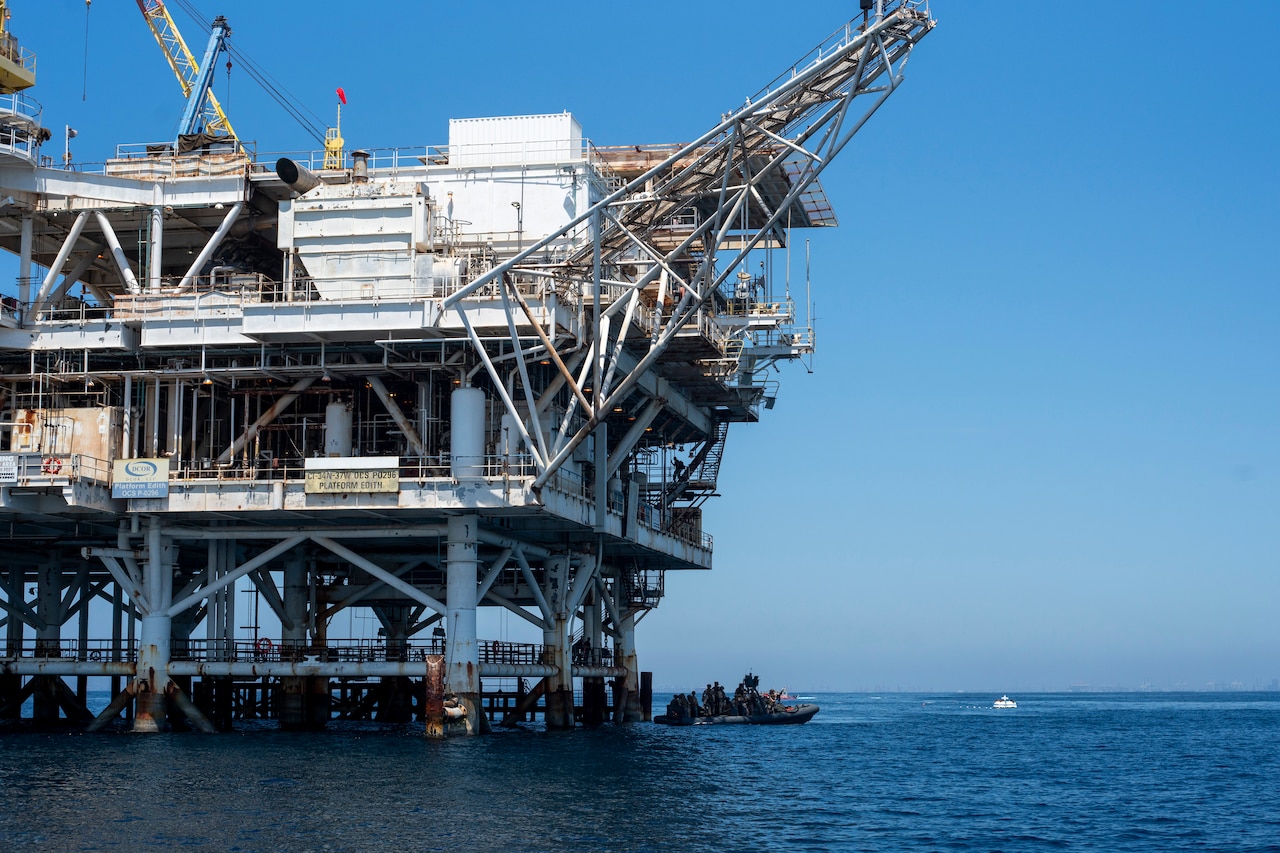 Marine climb up onto an oil rig platform.
