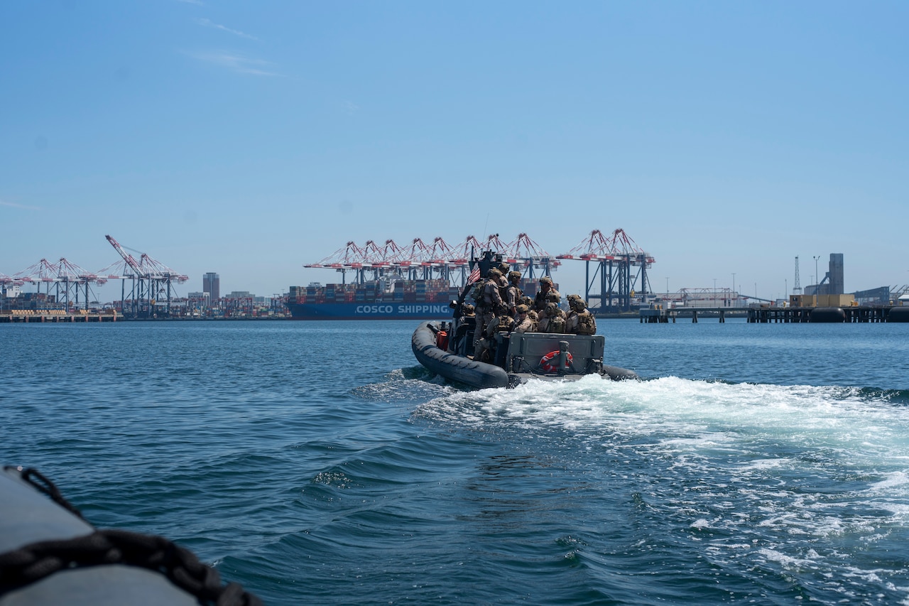 Marines ride in a rigid inflatable boat.
