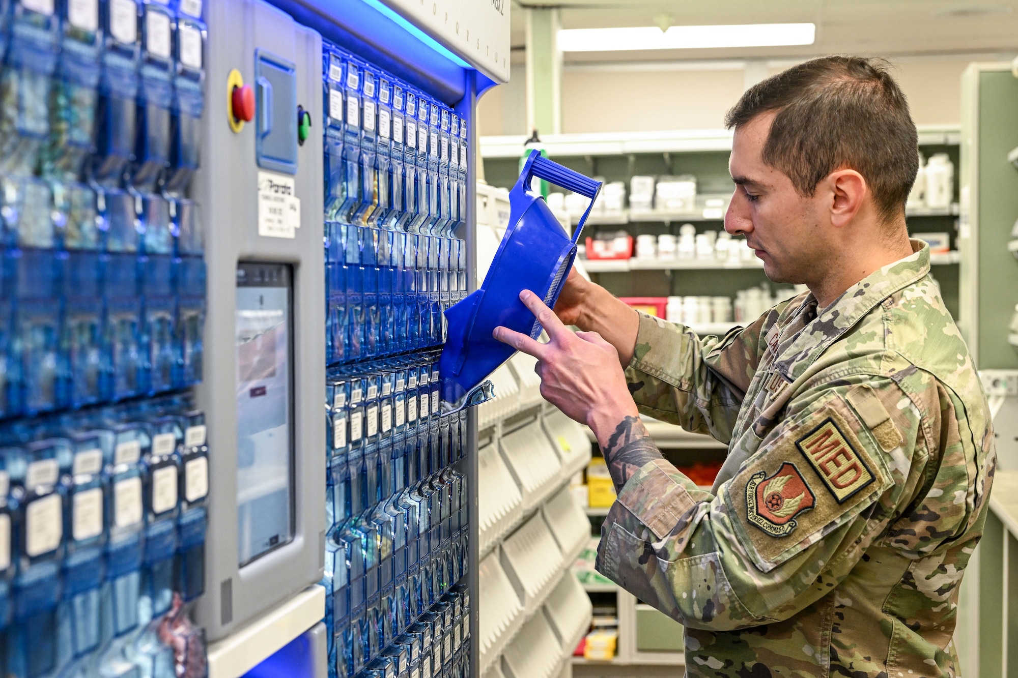 Technical Sgt. Marco Cardenas, 75th Medical Group Pharmacy Flight, restocks medications in the Parata Max 2 automated medication filling robot Oct. 26, 2023, at Hill Air Force Base