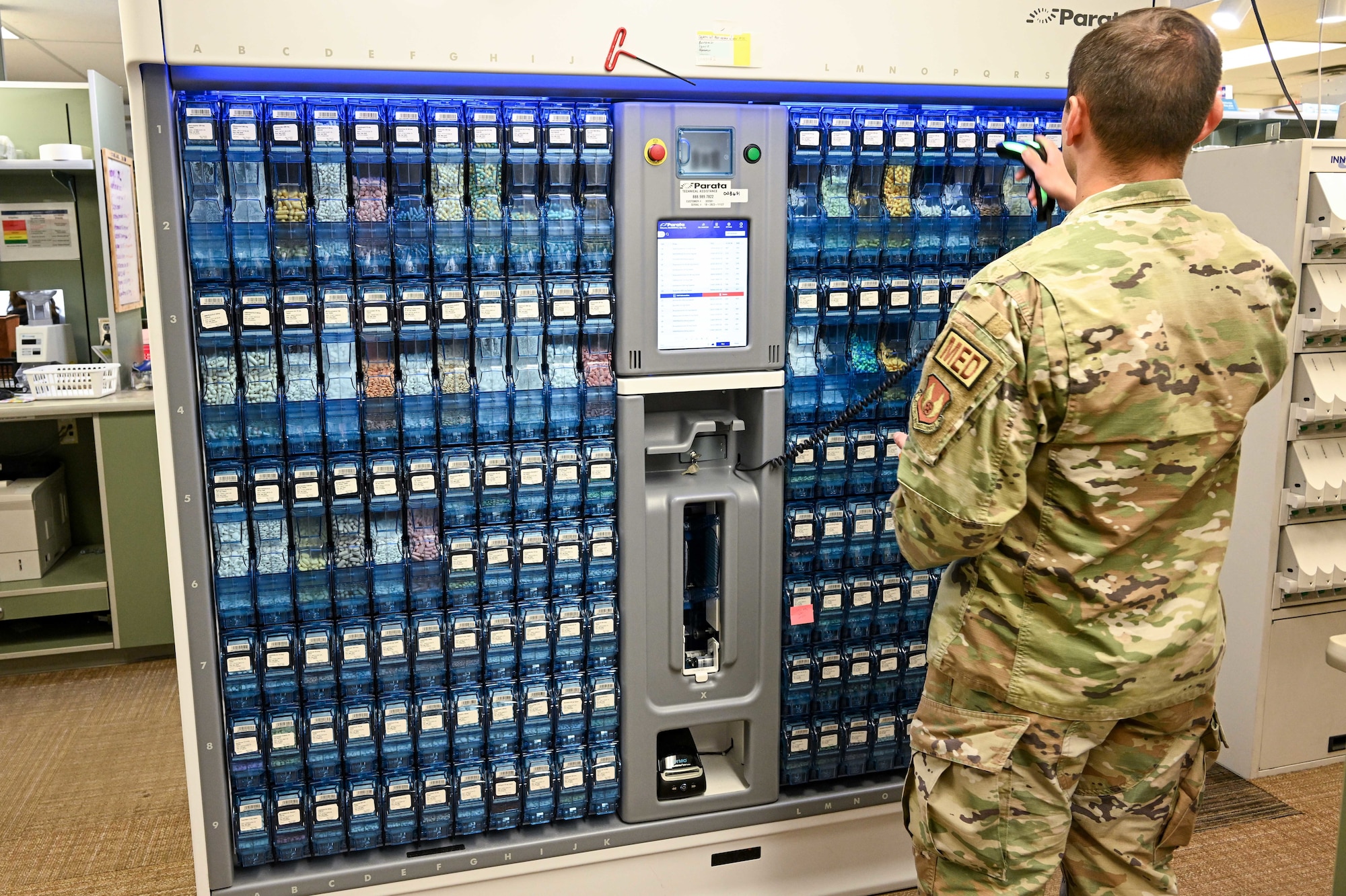 Technical Sgt. Marco Cardenas, 75th Medical Group Pharmacy Flight, scans medications in the Parata Max 2 automated medication filling robot Oct. 26, 2023, at Hill Air Force Base