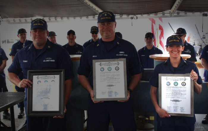 Electrician’s Mate First Class Petty Officer Dustin Thomas (left), Boatswain’s Mate First Class Petty Officer Shawn Wells (center), and Yeoman First Class Petty Officer Ashley Moulden (right) celebrate their reception into the hallowed ranks of Cuttermen aboard the CGC Willow on July 5, 2023. The Cutterman insignia signifies that they have exhibited the requisite professionalism and dedication to duty expected of seagoing Coast Guard personnel.