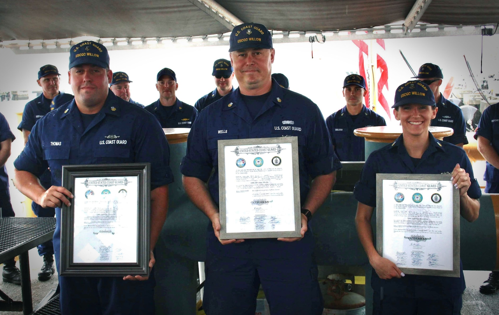 Electrician’s Mate First Class Petty Officer Dustin Thomas (left), Boatswain’s Mate First Class Petty Officer Shawn Wells (center), and Yeoman First Class Petty Officer Ashley Moulden (right) celebrate their reception into the hallowed ranks of Cuttermen aboard the CGC Willow on July 5, 2023. The Cutterman insignia signifies that they have exhibited the requisite professionalism and dedication to duty expected of seagoing Coast Guard personnel.