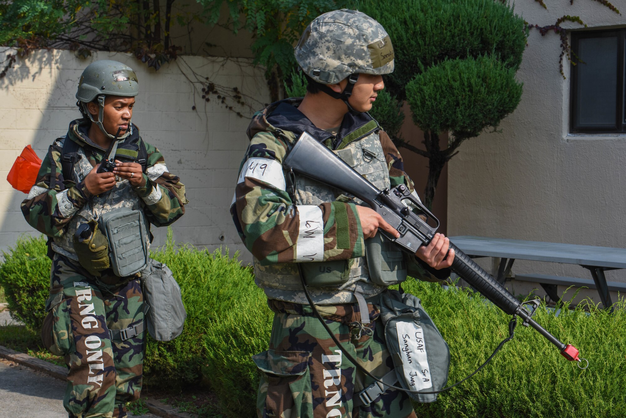 U.S. Air Force Staff Sgt. Mary Louise Van Diver, left, and Senior Airman Sanghun Jung, 51st Fighter Wing post attack reconnaissance team members, scan the area for simulated unexploded ordinance during Vigilant Defense 24 at Osan Air Base, Republic of Korea, Oct. 31, 2023. As the most forward deployed, permanently based wing in the air force, the 51st FW is charged with providing mission-ready Airmen to execute combat operations and receive follow-on forces. VD24 is a routine training event that tests the military capabilities across the peninsula, allowing combined and joint training at both the operational and tactical levels. (U.S. Air Force photo by Airman 1st Class Chase Verzaal)