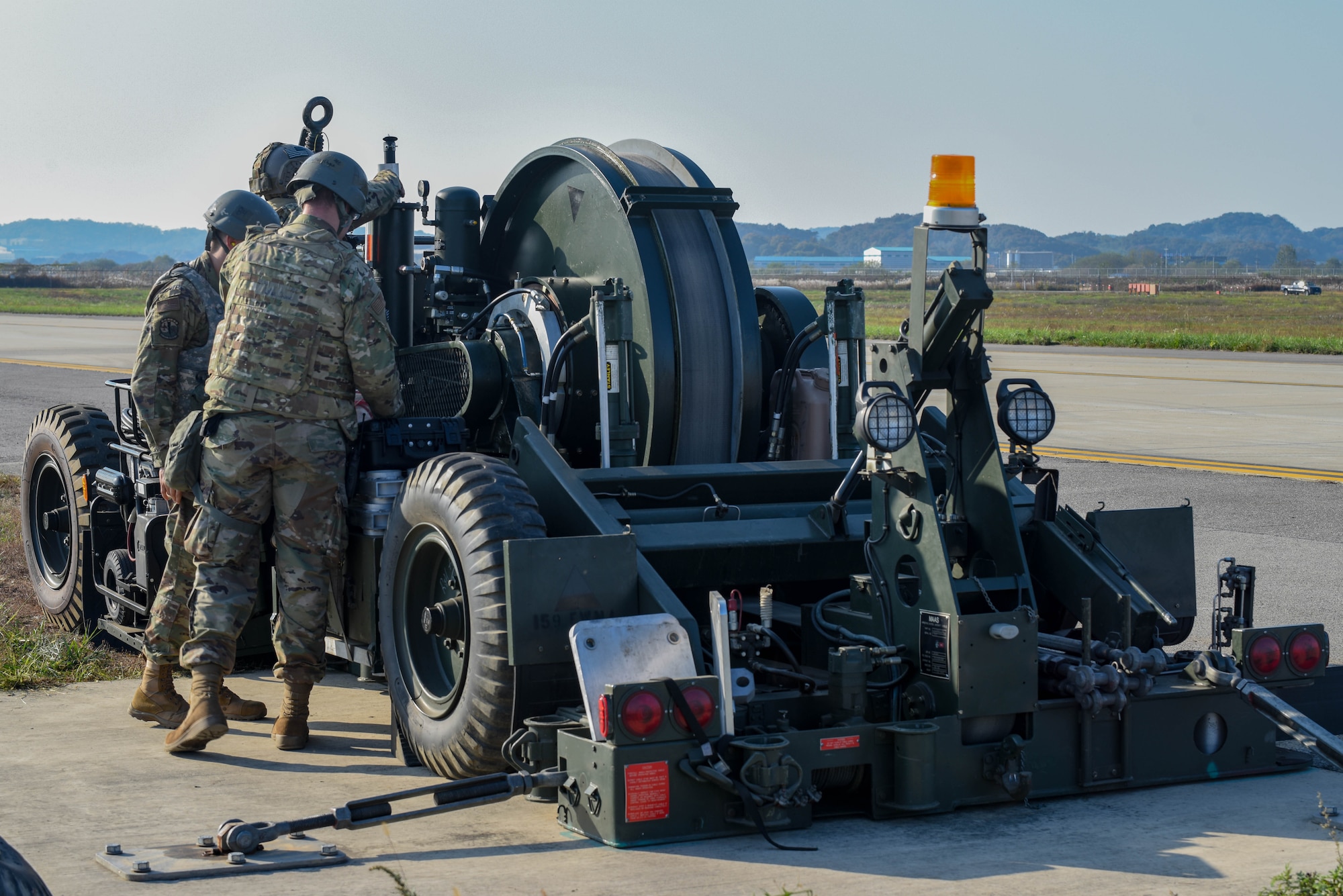 Airmen from the 51st Civil Engineer Squadron prepare an alternate landing strip for an F-16 Fighting Falcon landing during Vigilant Defense 24 at Osan Air Base, Republic of Korea, Oct. 29, 2023. The ALS is activated on the taxiway and turns it into a runway during contingencies. This reallocation of flightline space allows pilots to continue operating even if the runways are damaged. VD24 is a routine training event that tests the military capabilities across the peninsula, allowing combined and joint training at both the operational and tactical levels. (U.S. Air Force photo by Airman 1st Class Chase Verzaal)