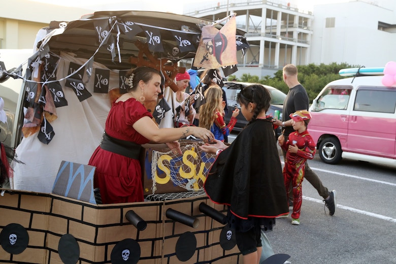 １０月２９日、海兵隊キャンプ・キンザーチャペルの駐車場に地元の小学生たちが招待され、トランク・オア・トリートに参加しました。
小学生たちは毎月キャンプ・キンザーSMPの地域交流イベントで交流のある児童センターの子供たちです。子供たちはチャペルのボランティアたちが準備した夕食を食べ、基地の子供たちと一緒にお菓子を貰いました。