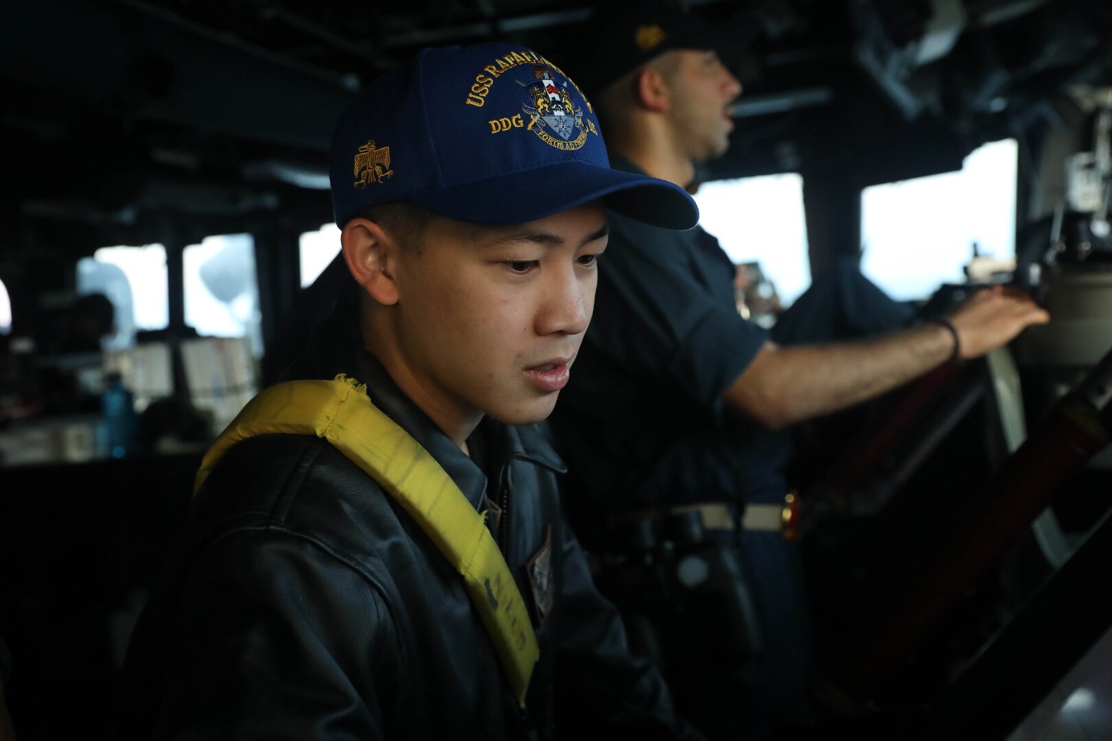231102-N-CV021-1078 TAIWAN STRAIT (Nov. 2, 2023) Lt. j.g. Bryan Nguyen, from Fairfax Station, Virginia, stands watch on the bridge aboard the Arleigh Burke-class guided-missile destroyer USS Rafael Peralta (DDG 115) in the Taiwan Strait, Nov. 2. Rafael Peralta is forward-deployed and assigned to Commander, Task Force 71/Destroyer Squadron (DESRON) 15, the Navy’s largest DESRON and the U.S. 7th Fleet’s principal surface force. (U.S. Navy photo by Mass Communication Specialist 3rd Class Alexandria Esteban)