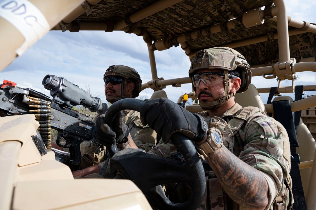 Two security forces members in a RAZR all-terrain vehicle
