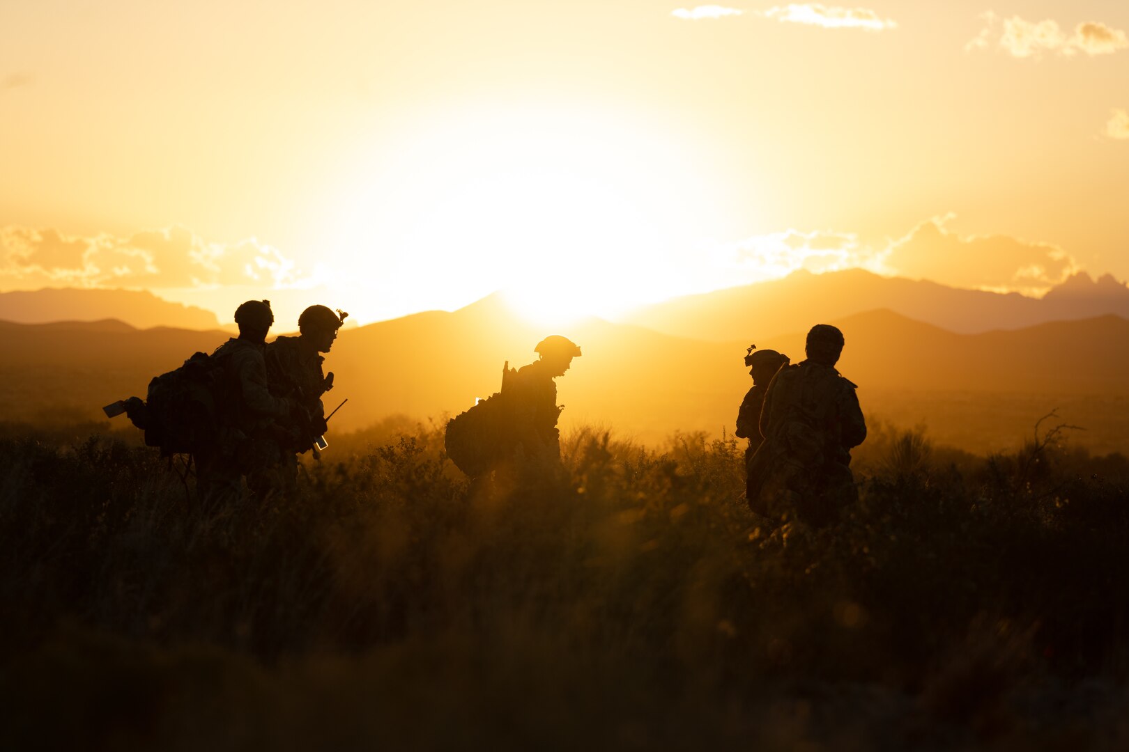 Security forces Airmen operate in the desert at sunset