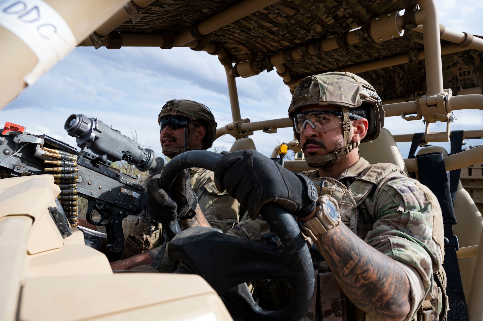 Two security forces members in a RAZR all-terrain vehicle