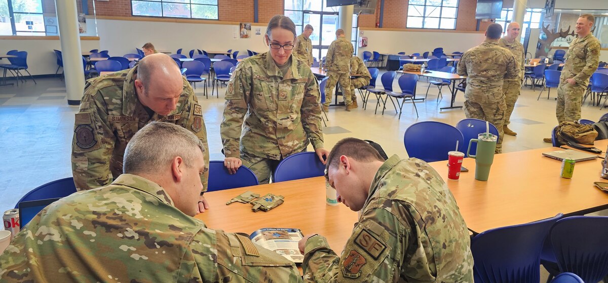 Airmen looking at trauma kits