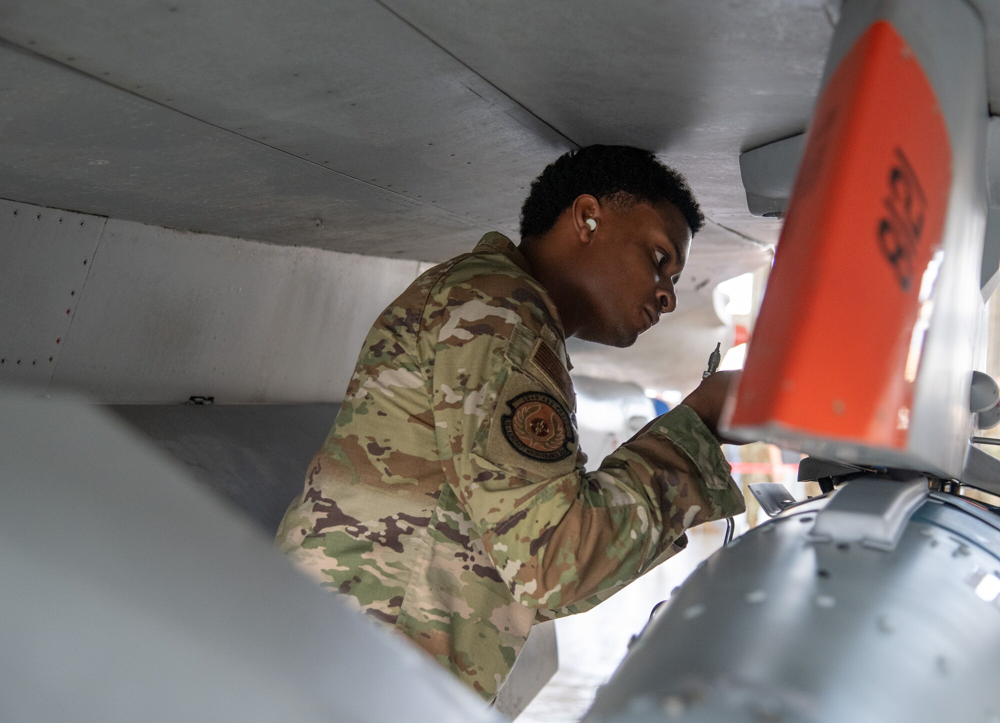 An Airman performs pre-load procedures on an F-16 Fighting Falcon.