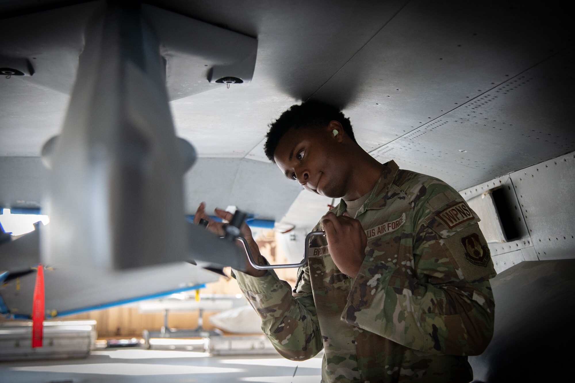 An Airman performs pre-load procedures on an F-16 Fighting Falcon.