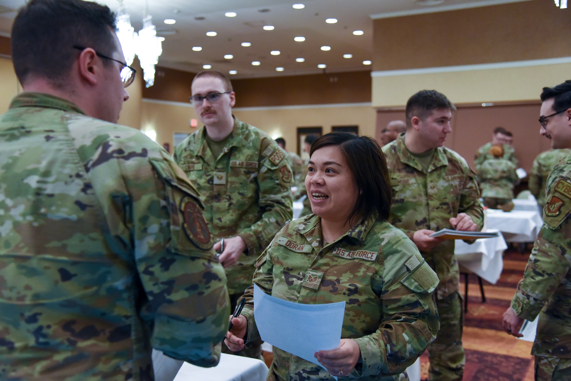 Airmen interacting with one another during a professional development.