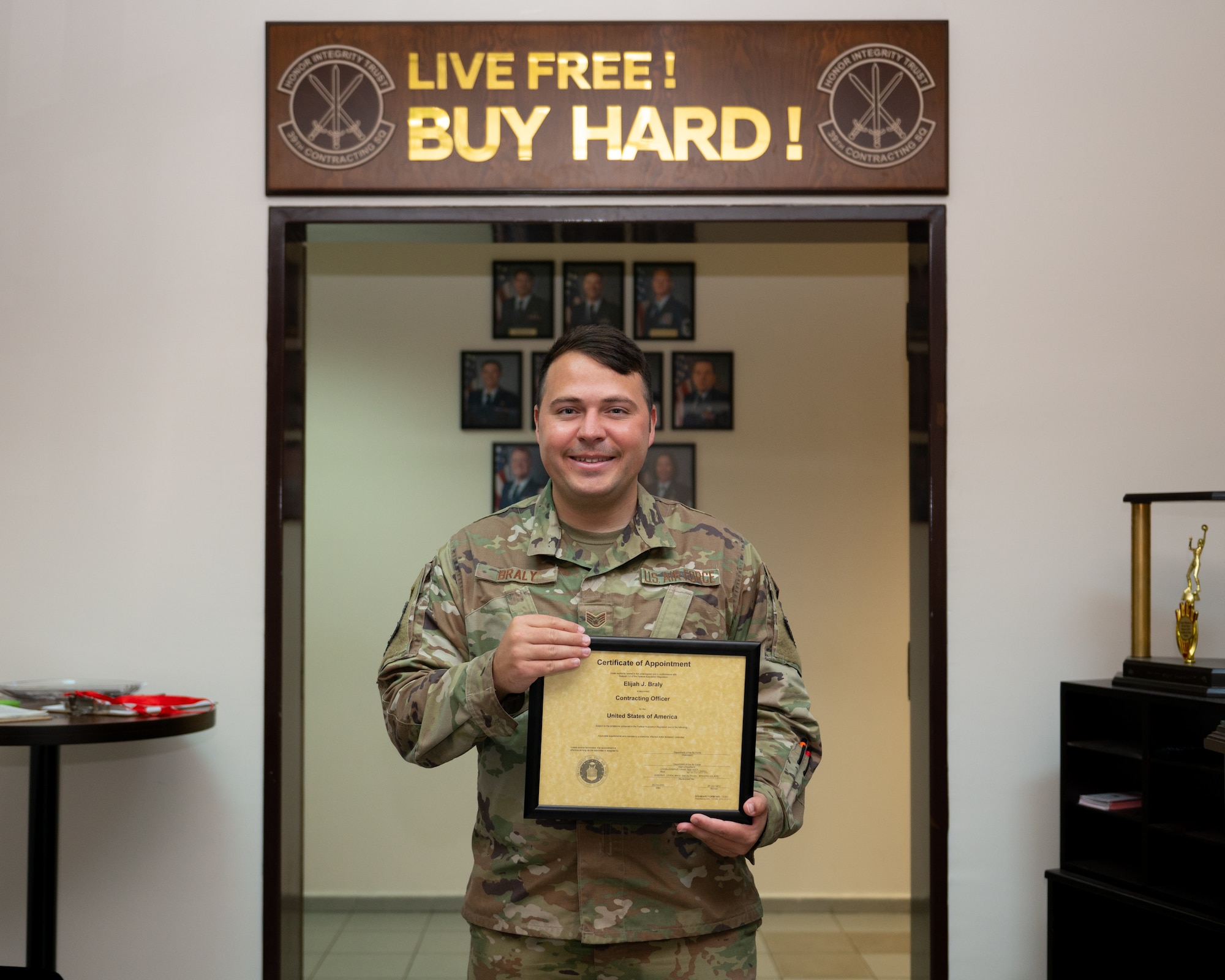 An Airman poses with certificate.