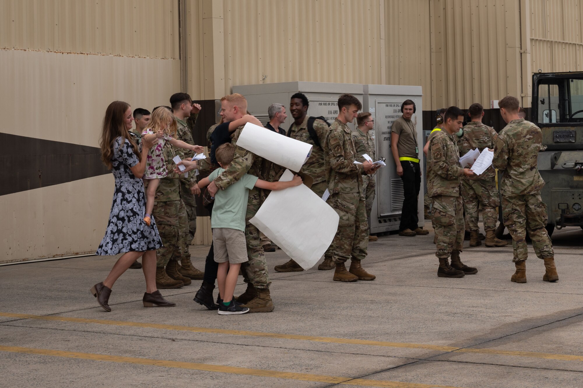 An Airman assigned to the 336th Fighter Generation Squadron greets his family during a homecoming ceremony at Seymour Johnson Air Force Base, North Carolina, Oct. 6, 2023.  After six months deployed, the Airmen were welcomed back to Seymour Johnson AFB by their families and friends. (U.S. Air Force photo by Airman 1st Class Rebecca Sirimarco-Lang)