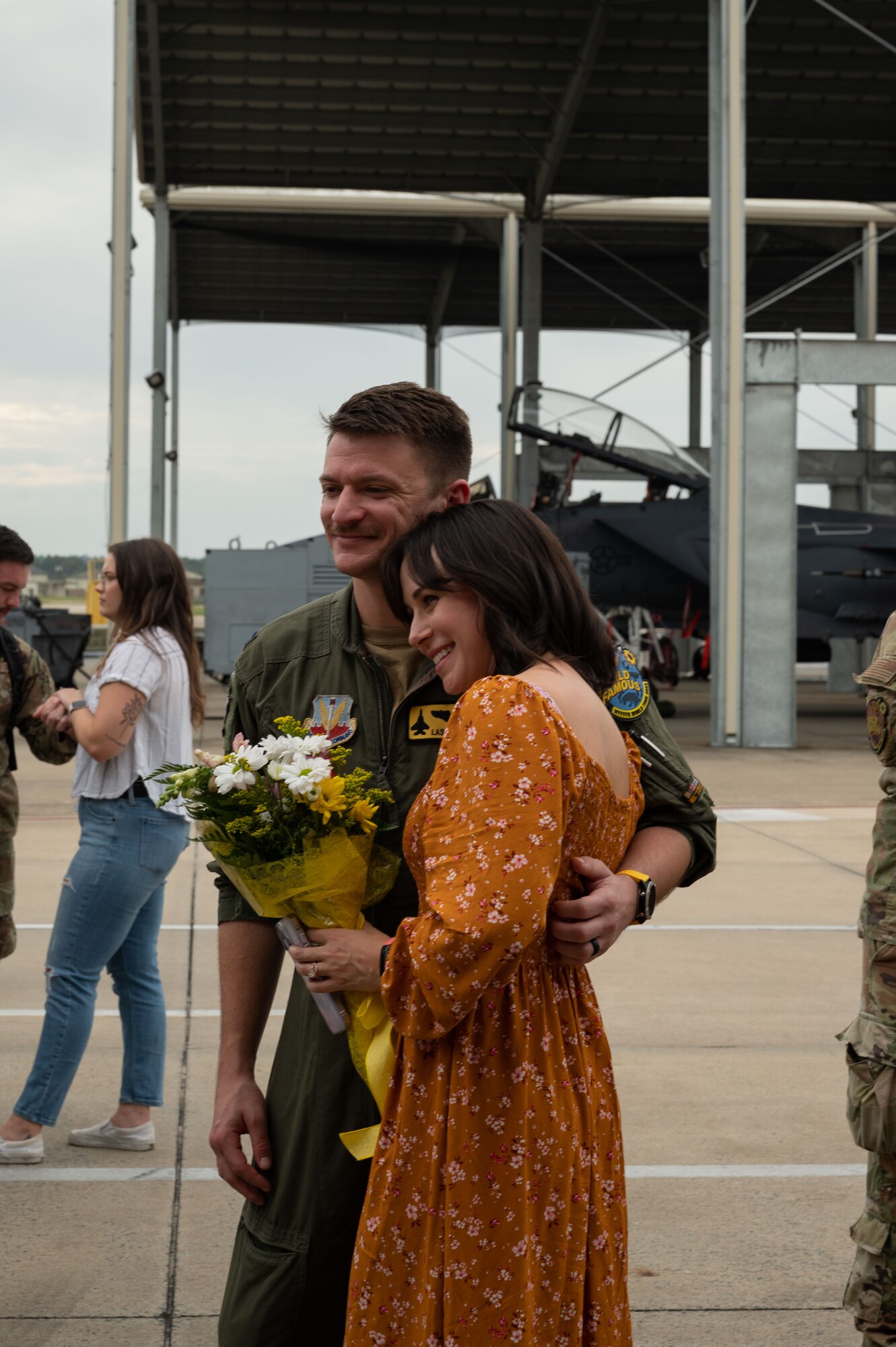 An Airman assigned to the 336th Fighter Squadron greets his family during a homecoming ceremon  at Seymour Johnson Air Force Base, North Carolina, Oct. 6, 2023. While deployed, aircrew remained available at any given time to defend against air or ground threats. (U.S. Air Force photo by Airman 1st Class Rebecca Sirimarco-Lang)