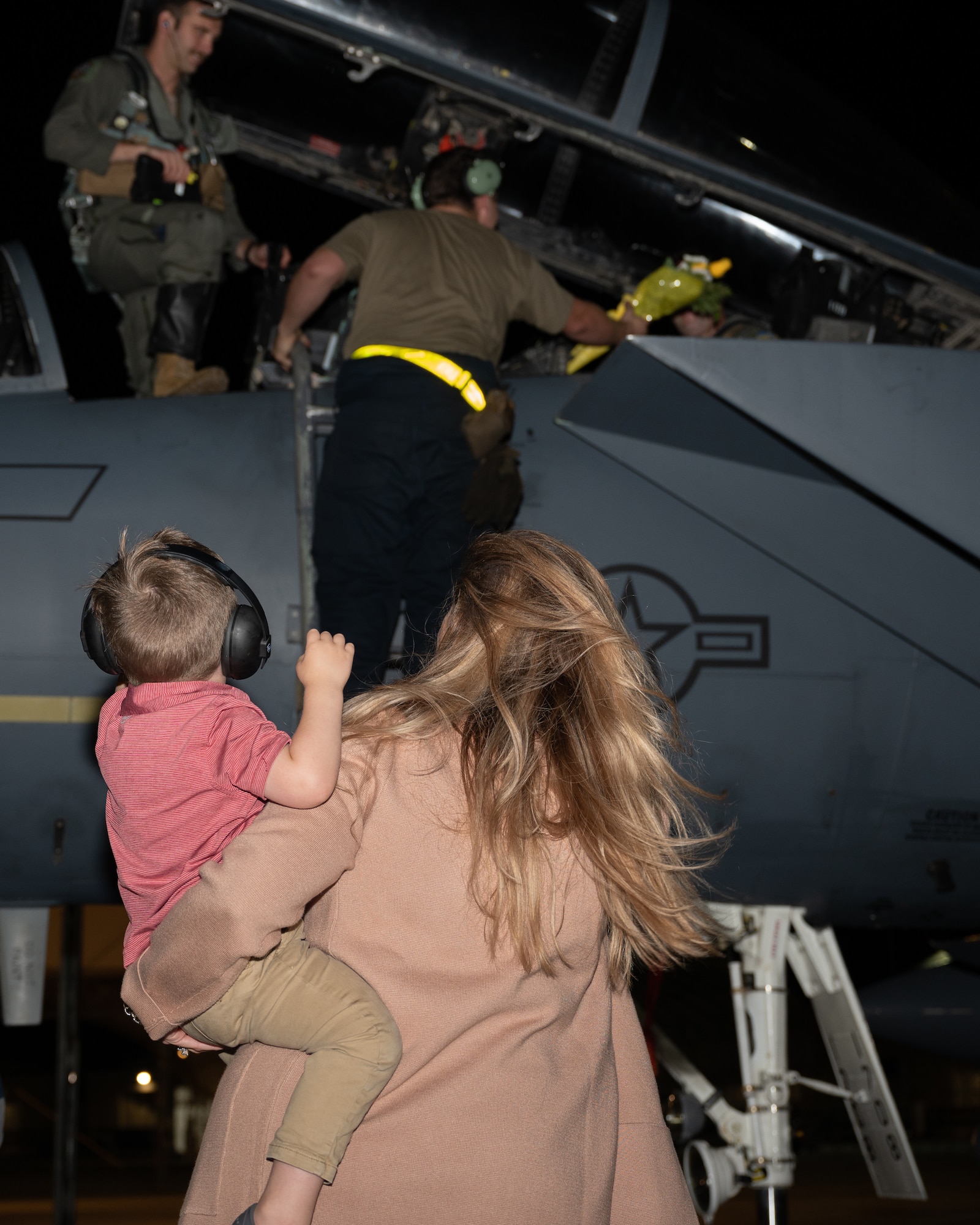 A family waits to reunite with their Airman during a homecoming ceremony at Seymour Johnson Air Force Base, North Carolina, Oct. 30, 20223. While deployed, aircrew remained available at any given time to defend against air or ground threats. (U.S. Air Force photo by Airman 1st Class Rebecca Sirimarco-Lang)