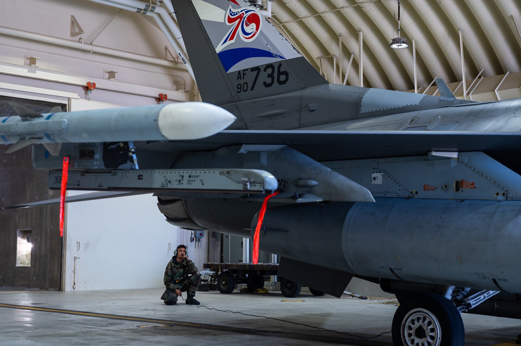 Airman First Class Alex Goodnow inspects the tail of an F-16 Fighting Falcon during preflight checks during Vigilant Defense 24.