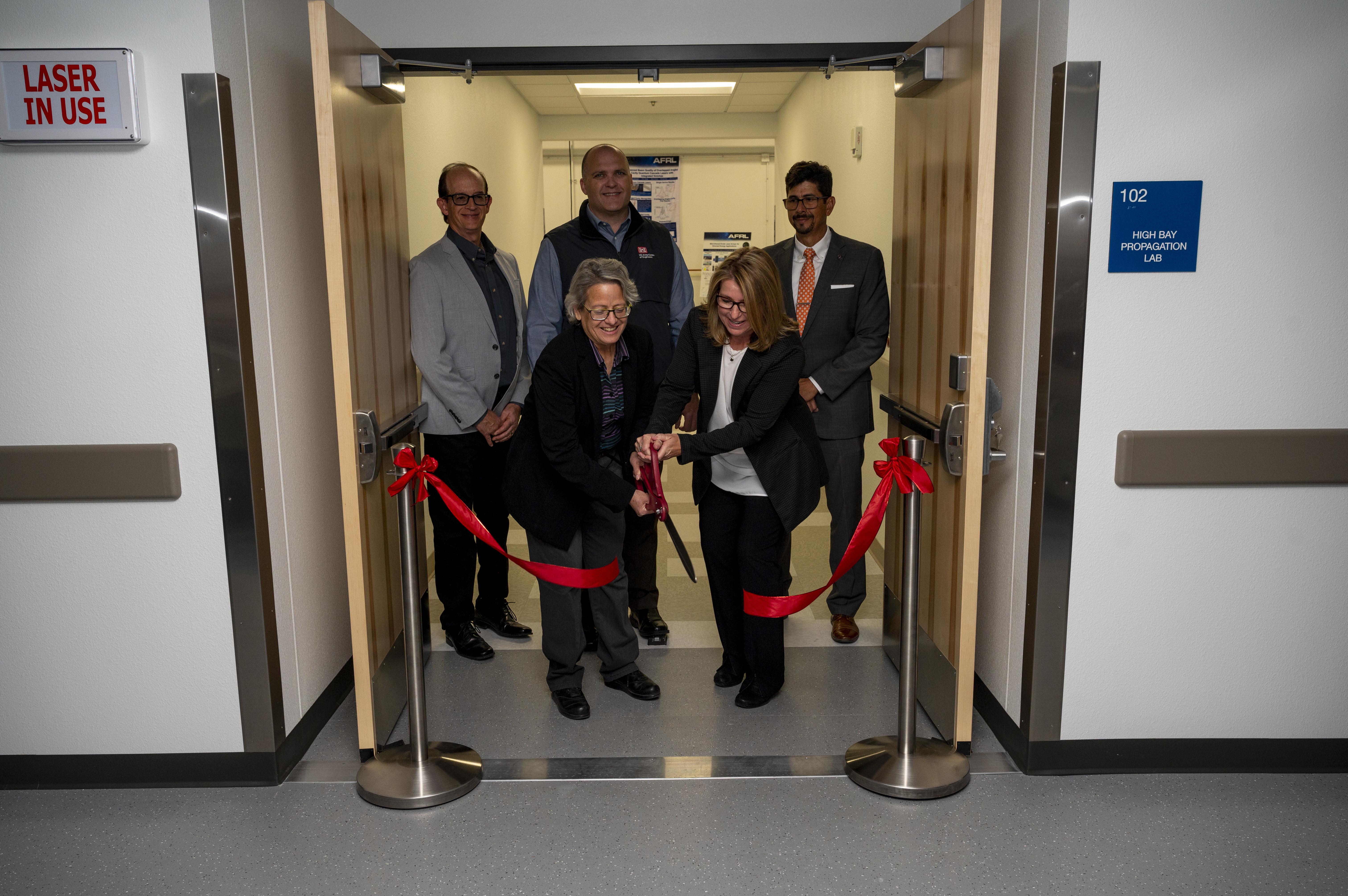 Dr. Shery Welsh, Air Force Laboratory directed energy directorate director, and Dr. Imelda Atencio, AFRL’s directed energy laser division chief, conduct a ribbon cutting ceremony in celebration of the new Semiconductor Laser Indoor Propagation Range on Kirtland Air Force Base, N.M., Oct. 17, 2023. The range will serve to further aid AFRL in the research and development of propagation studies to fill in critical technology gaps. (U.S. Air Force photo / Airman 1st Class Ruben Garibay)
