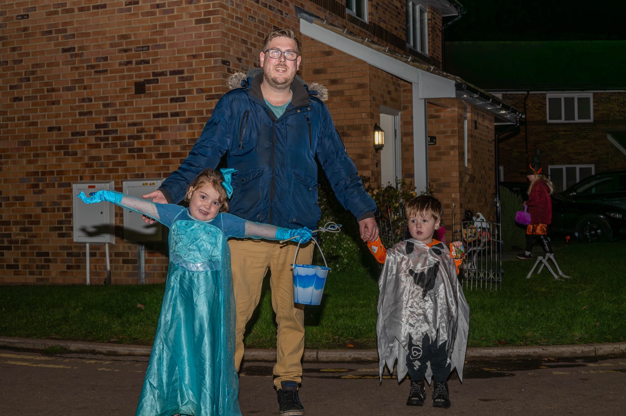 Trick or treaters pose for a photo