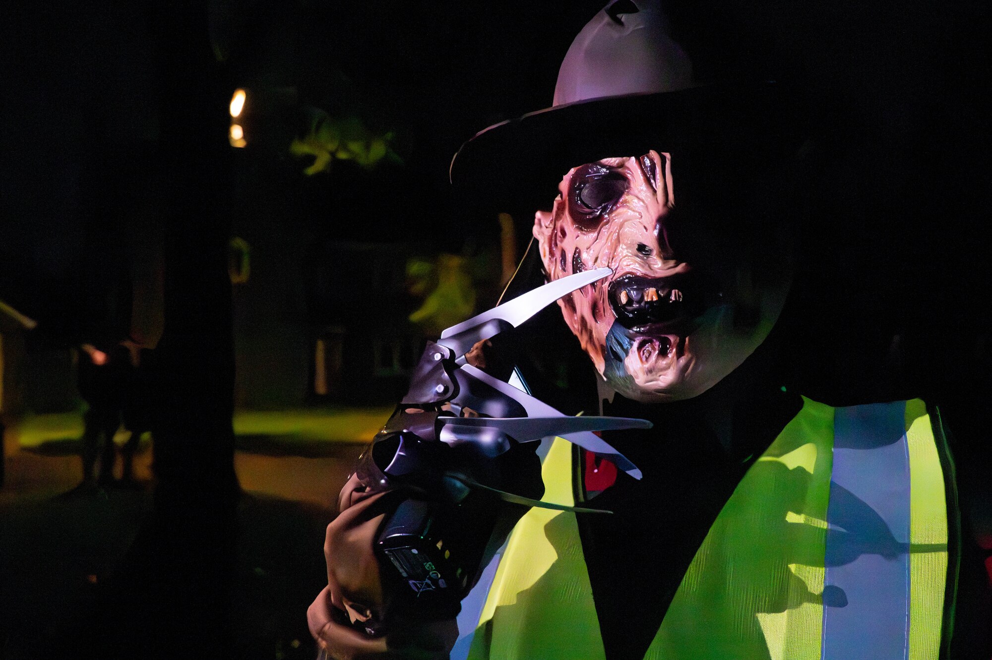 A volunteer dressed as Freddy Krueger speaks over a walkie talkie