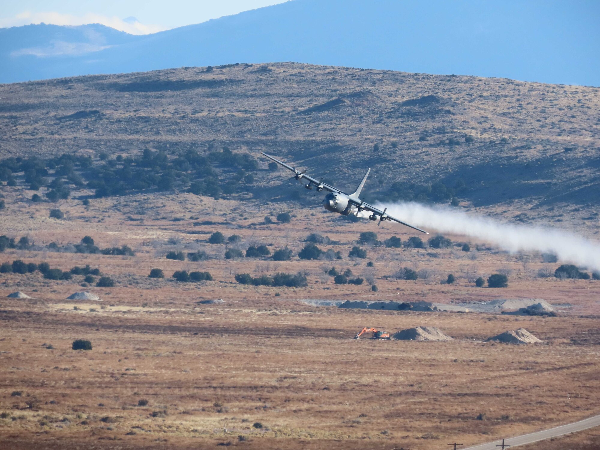 A C-130H Hercules aircraft from Youngstown Air Reserve Station, Ohio, applies herbicide to the Utah Test and Training Range, Hill Air Force Base,  to create fire breaks for wildfire prevention and safe unexploded ordnance removal, Oct. 28, 2023.