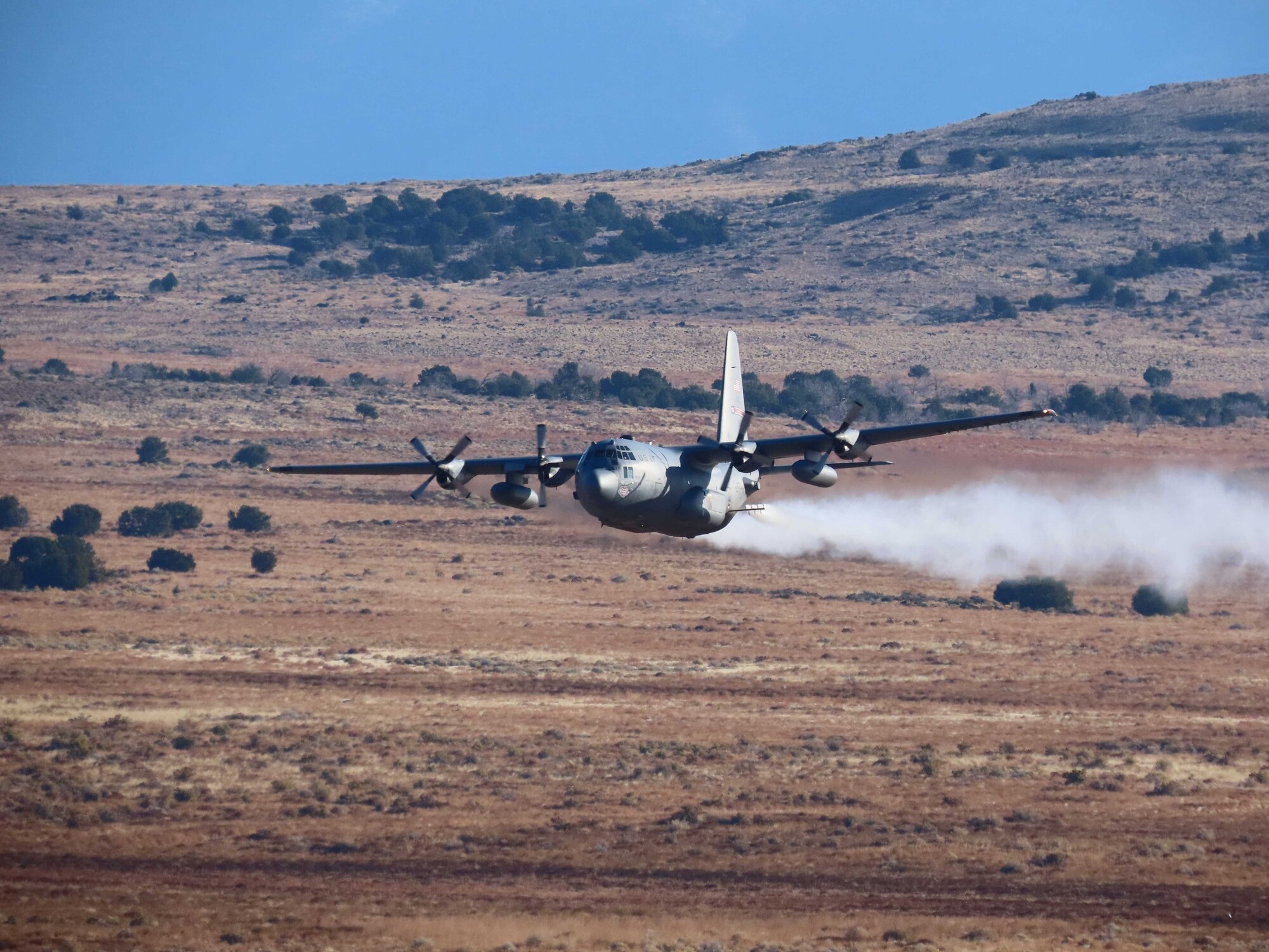 A C-130H Hercules aircraft from Youngstown Air Reserve Station, Ohio, applies herbicide to the Utah Test and Training Range, Hill Air Force Base,  to create fire breaks for wildfire prevention and safe unexploded ordnance removal, Oct. 28, 2023.