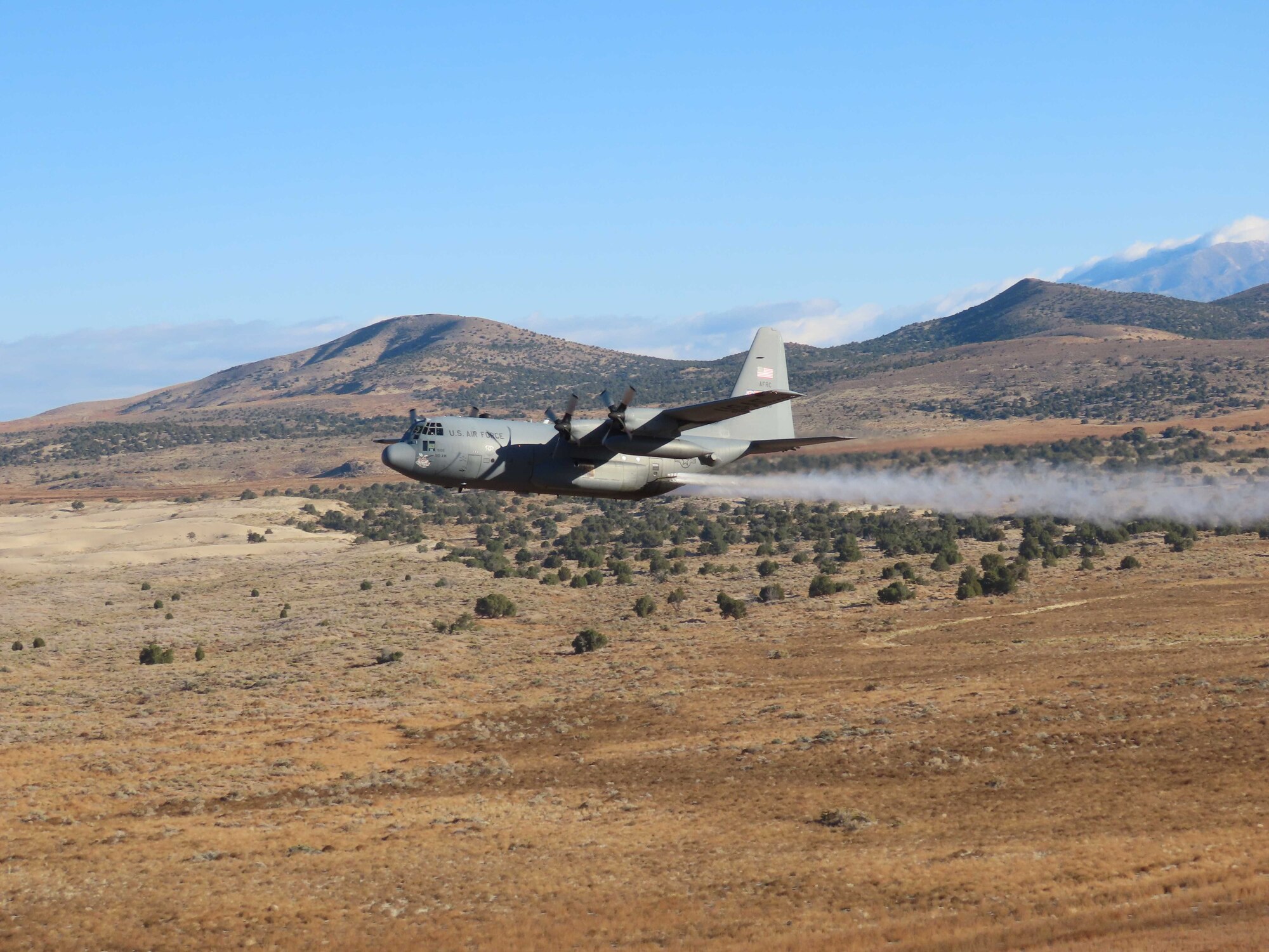 A C-130H Hercules aircraft from Youngstown Air Reserve Station, Ohio, applies herbicide to the Utah Test and Training Range, Hill Air Force Base,  to create fire breaks for wildfire prevention and safe unexploded ordnance removal, Oct. 28, 2023.