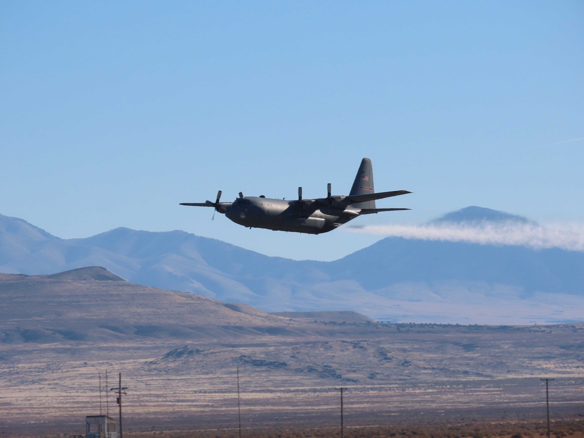A C-130H Hercules aircraft from Youngstown Air Reserve Station, Ohio, applies herbicide to the Utah Test and Training Range, Hill Air Force Base,  to create fire breaks for wildfire prevention and safe unexploded ordnance removal, Oct. 31, 2023.
