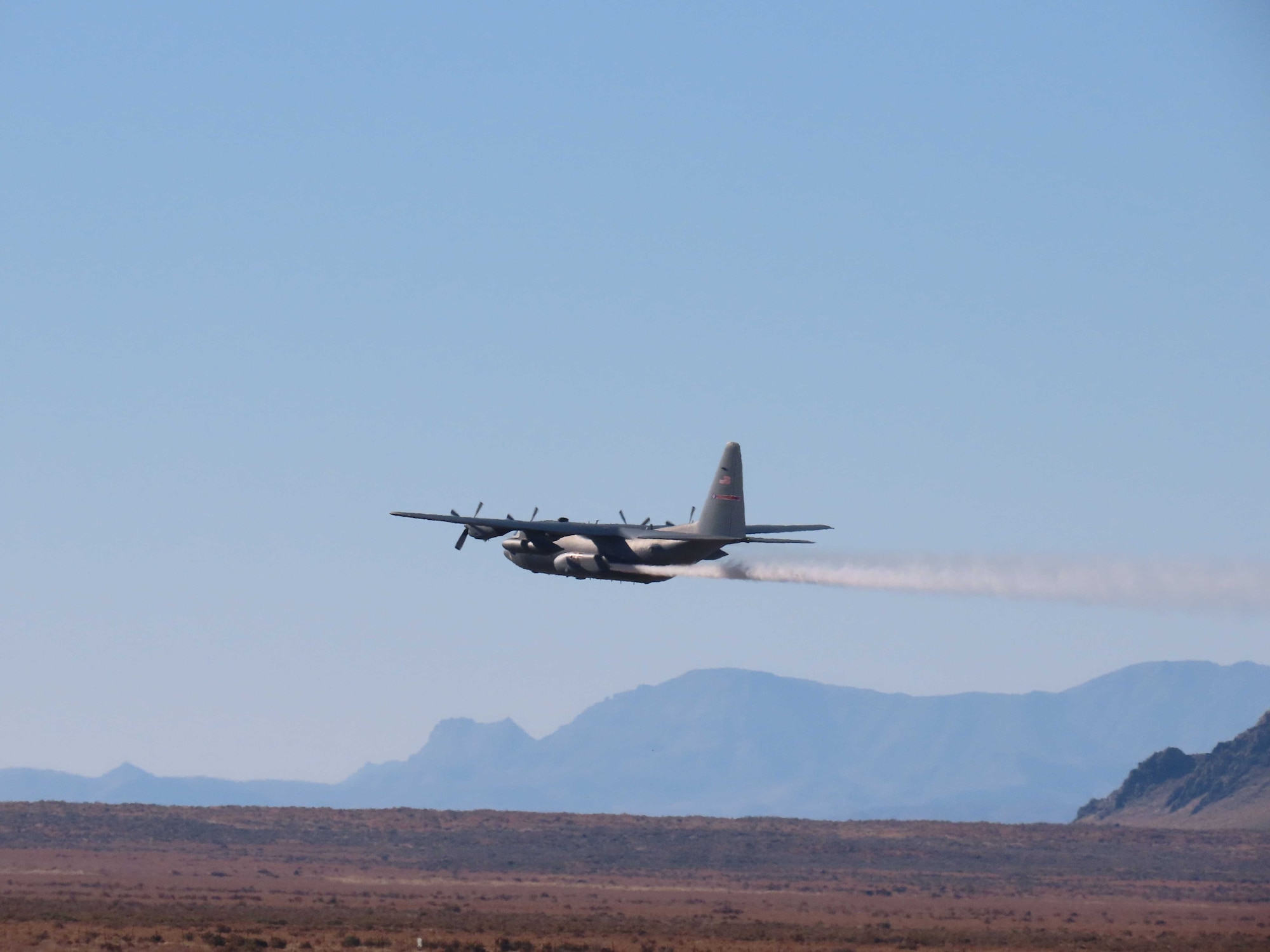 A C-130H Hercules aircraft from Youngstown Air Reserve Station, Ohio, applies herbicide to the Utah Test and Training Range, Hill Air Force Base,  to create fire breaks for wildfire prevention and safe unexploded ordnance removal, Oct. 31, 2023.