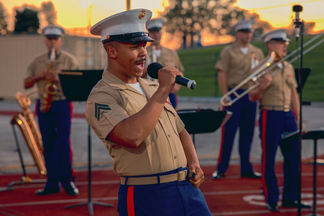 U.S. Marine Corps Cpl. Britt Camren, a Dover, Delaware native and musician with the 2d Marine Division Band sings during a high school football game at Northeast high school during Navy-Marine Corps Week, Philadelphia, Pennsylvania, Oct. 13, 2023. The Navy-Marine Corps Week allows service members to participate in community outreach by showcasing the Marine Corps capabilities while educating and connecting with the public through static displays, band performances and Silent Drill platoon performances. (U.S. Marine Corps photo by Cpl. Max Arellano)