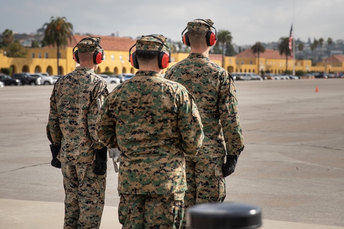 U.S. Marines stand at attention before a 19 cannon "volley of fire" in honor of the Secretary of the Navy, the Honorable Mr. Carlos del Toro, at Marine Corps Recruit Depot San Diego, Oct. 27, 2023. Mr. del Toro visited MCRD San Diego to observe a graduation ceremony and meet with base personnel. (U.S. Marine Corps photo by Cpl. Elliott A. Flood-Johnson)