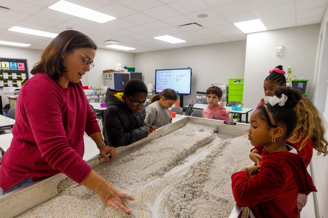 Marion Margaret Hern, a STEM teacher at Bovina Elementary School, explains the Fluvial processes to her students showcased by the ERDC Mobile STEM Lab.