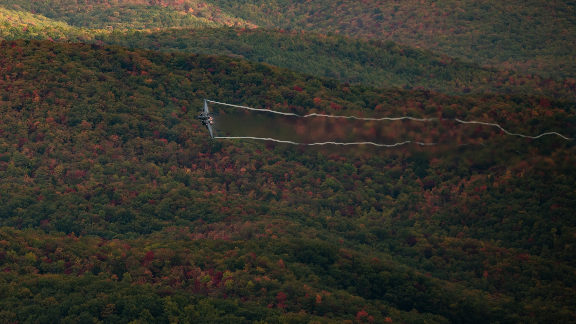 An F-15E Strike Eagle assigned to the 4th Fighter Wing flies over the Appalachian Mountains near Linville, North Carolina, Oct. 16, 2023. The 4th Fighter Wing performs routine flight training to ensure that they are able to project agile combat airpower for the United States and its allies. (U.S. Air Force photo by Airman 1st Class Rebecca Sirimarco-Lang)