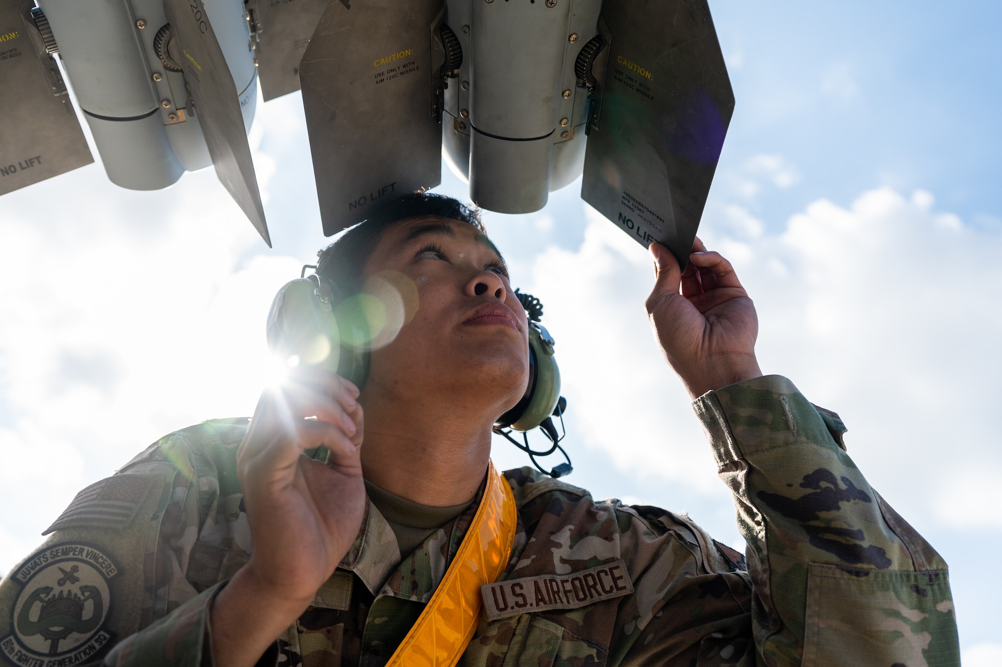 Airman First Class Darren Ky inspects ammunition before they are loaded onto a U.S. Air Force F-16 Fighting Falcon.