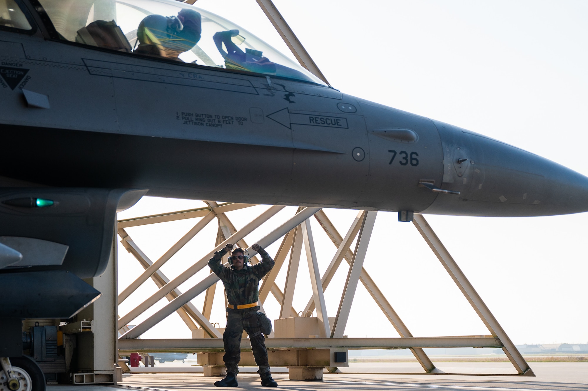 Airman First Class Alex Goodnow and Capt. Carter Kozacek, F-16 Fighting Falcon pilot share a gesture of squadron pride, signaling all preflight checks are complete and the aircraft is ready for takeoff during Vigilant Defense 24.