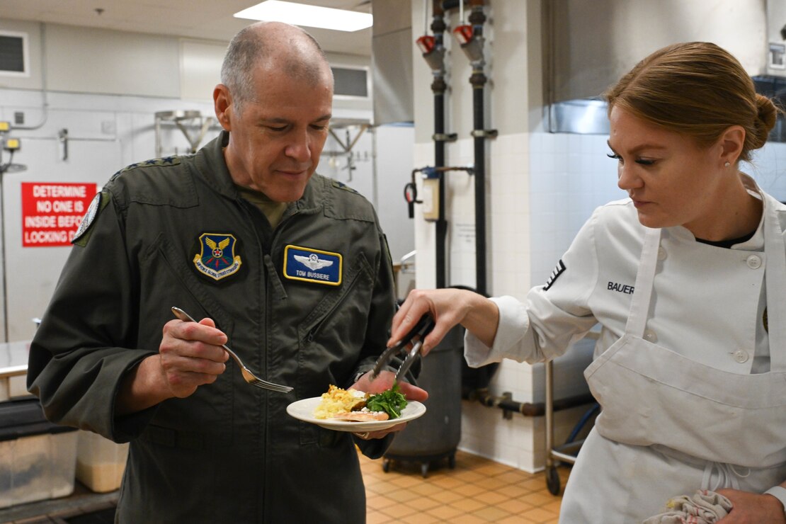 Tech. Sgt. Kelsey Bauers gives Gen. Bussiere food