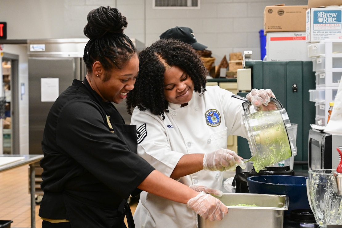 Tech Sgt. Shameka Risch and Senior Airman Rachell Mitchell make filling for beef patties.