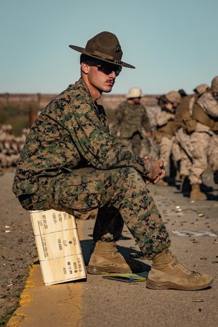 U.S. Marine Corps Primary Marksmanship Instructor, Cpl. Jeffrey Scott V, observes recruits shooting techniques to provide feedback during a table two course of fire at Marine Corps Base Camp Pendleton, California, Oct. 31, 2023. The table two course of fire teaches recruits the fundamentals of safety and marksmanship in combat shooting positions and rifle carries. (U.S. Marine Corps photo by Cpl. Alexander O. Devereux)