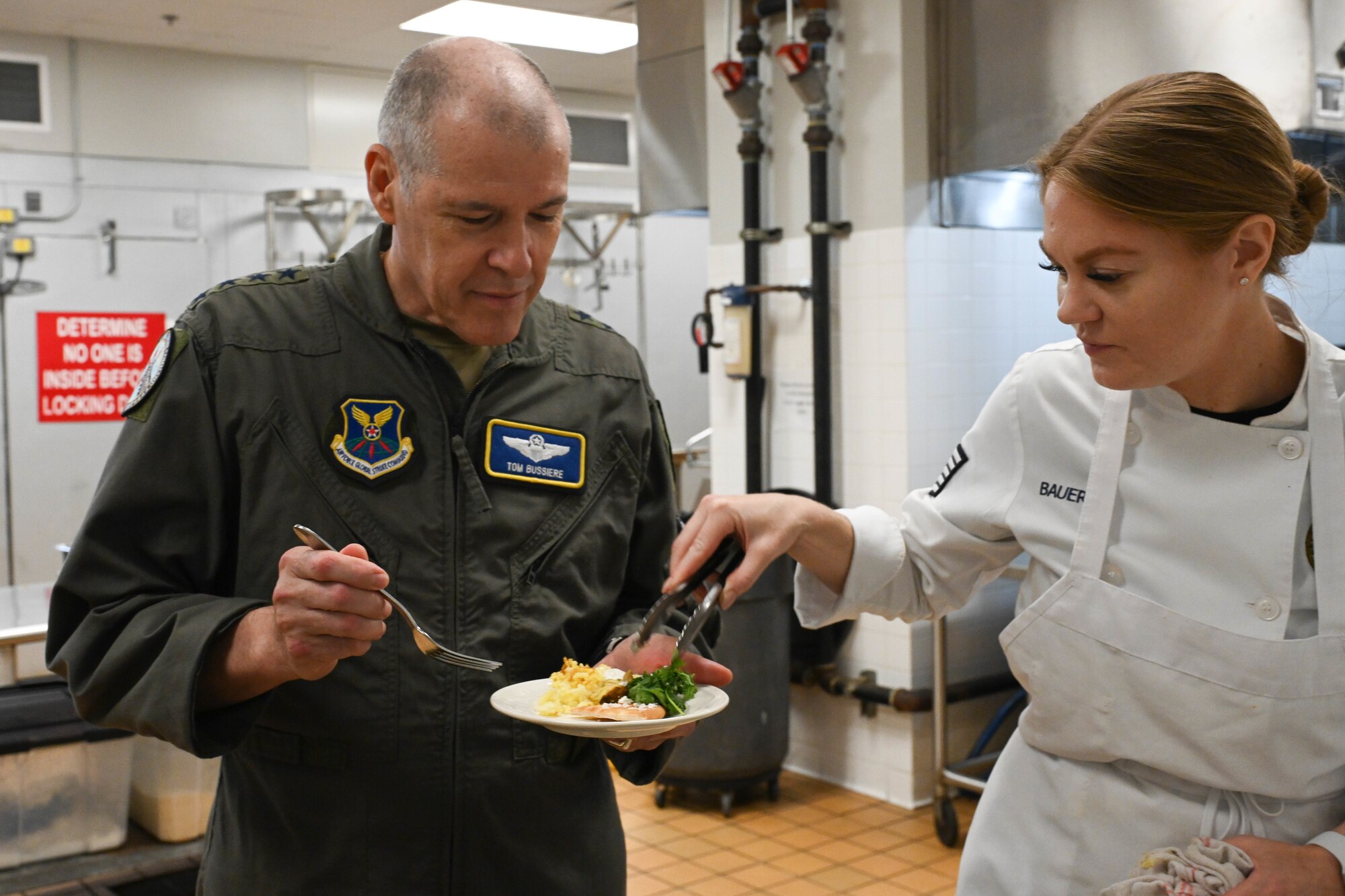 Tech. Sgt. Kelsey Bauers gives Gen. Bussiere food