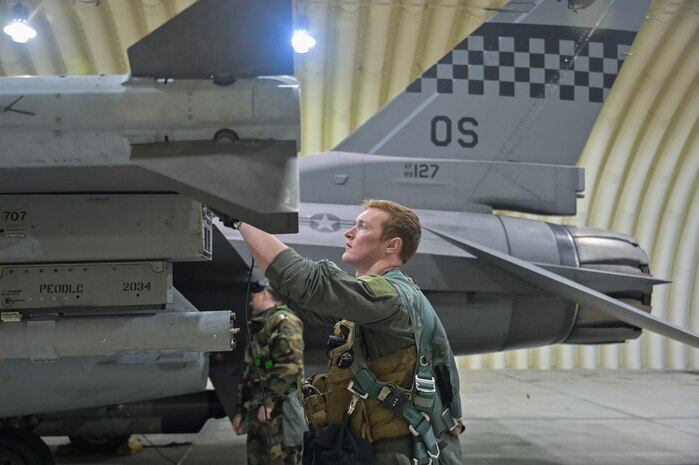 Capt. Thomas Molnar conducts preflight checks with 8th Maintenance Squadron crew chiefs prior to taking off during Vigilant Defense 24.