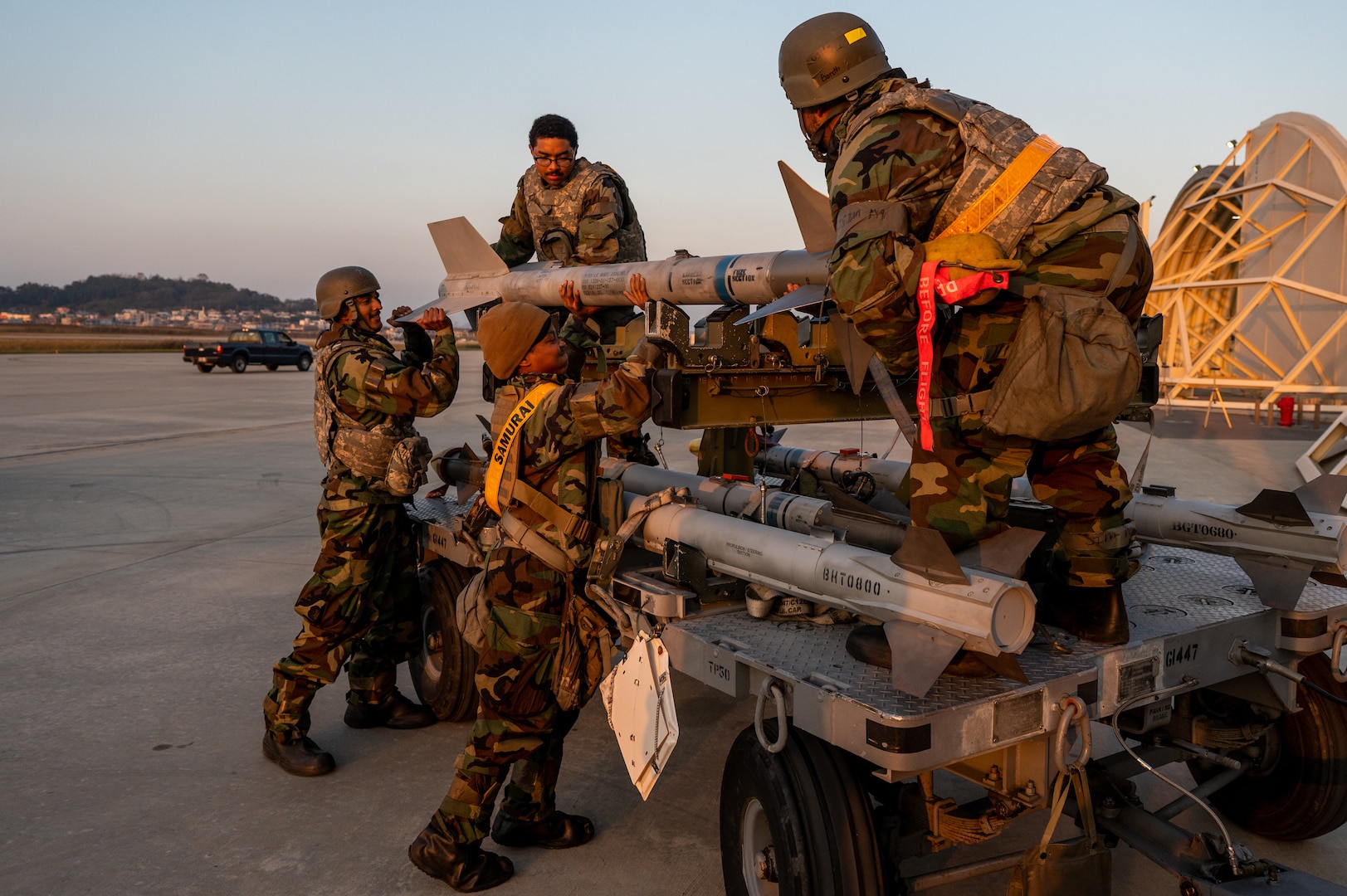 A team of 80th Fighter Generation Squadron weapons load crew members work in unison to move ammunition during Vigilant Defense 24.
