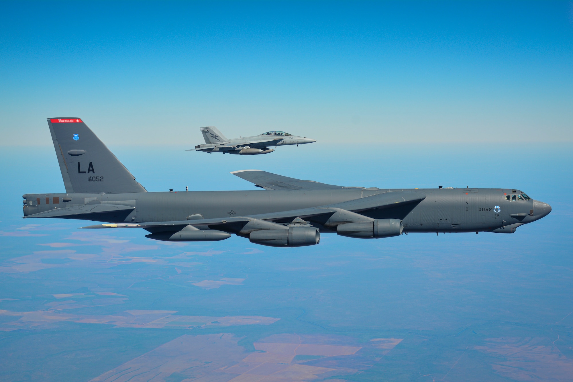 A United States Air Force B-52H Stratofortress and a Royal Australian Air Force F/A-18F Super Hornet flying over the Northern Territory during Exercise Talisman Sabre 23. Talisman Sabre enables the U.S. and Australia to exercise our combined capabilities to conduct high-end, multi-domain warfare, to build and affirm our military-to-military ties and interoperability, and strengthen our strategic partnerships. (U.S. Air Force Courtesy Photo)