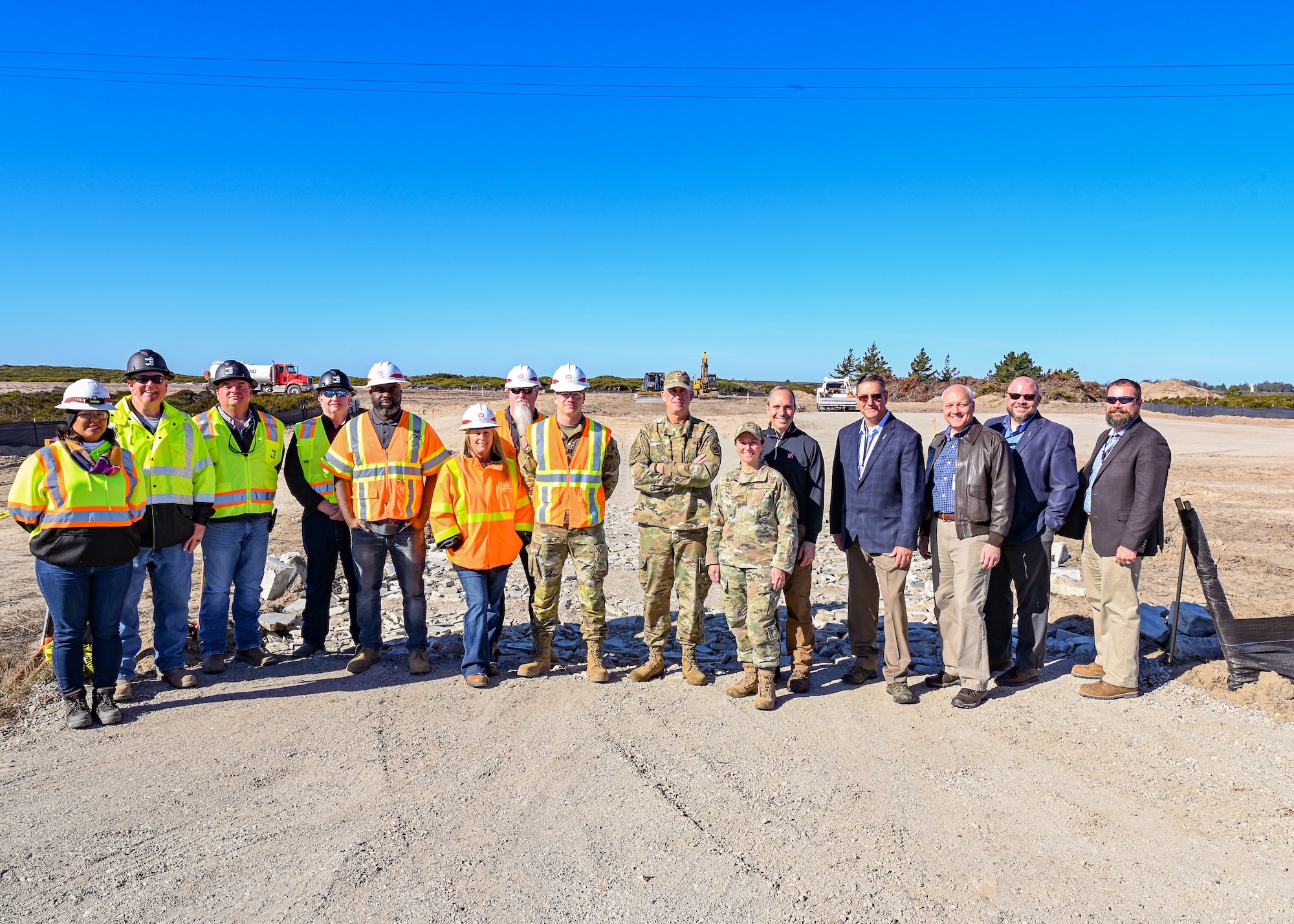 Air Force Global Strike Command ICBM Modernization director poses for a photo with engineers and his official party at Vandenberg Space Force Base.