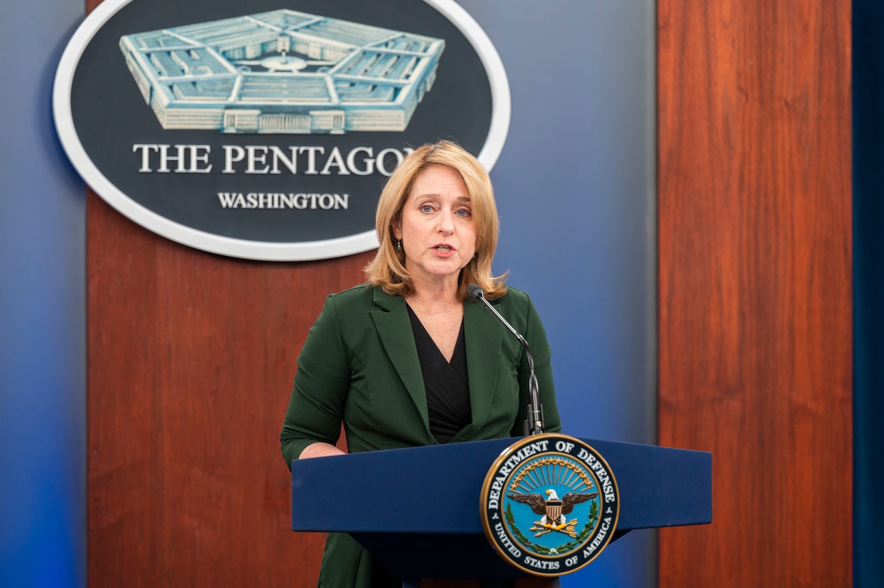 A woman speaks from a podium.